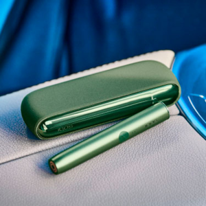 A person placing a TEREA stick into an IQOS ILUMA Holder.